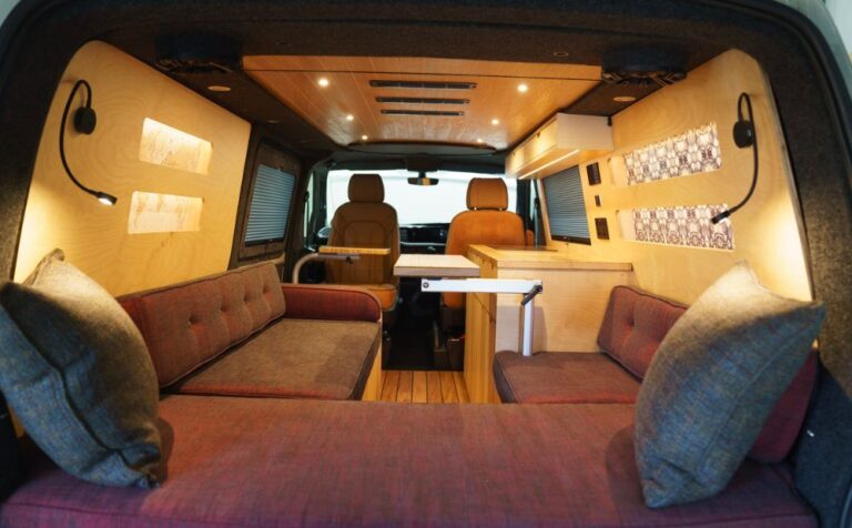 rear view of Campervan conversion featuring burgundy upholstery and a wooden kitchen