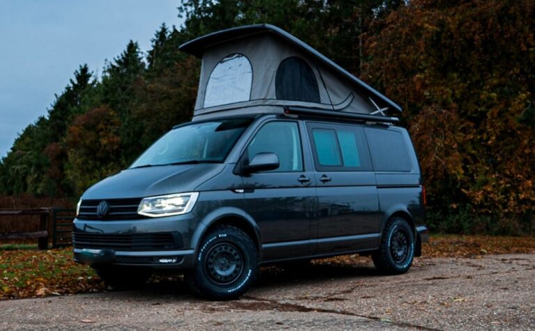 Grey VW Campervan with roof up outside