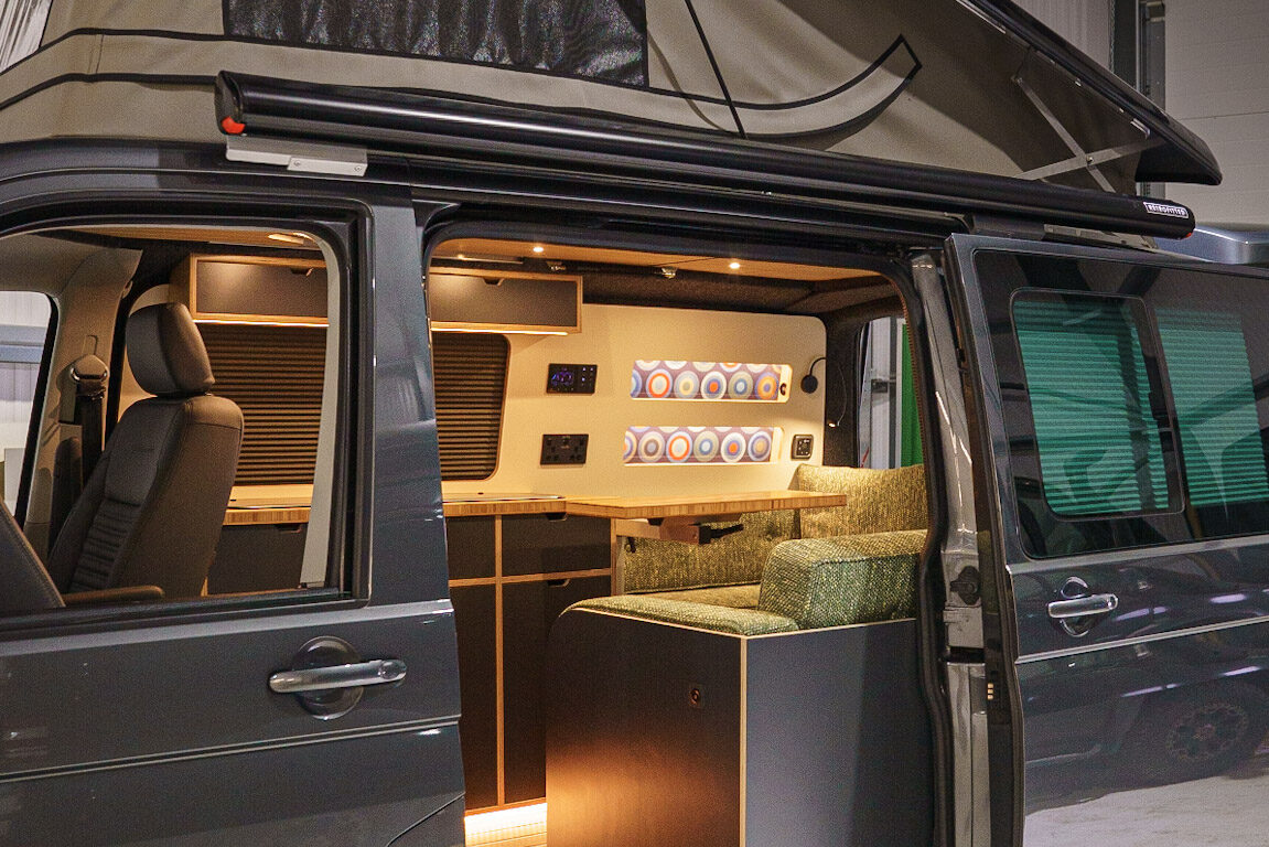 Campervan interior with sliding door open and roof up