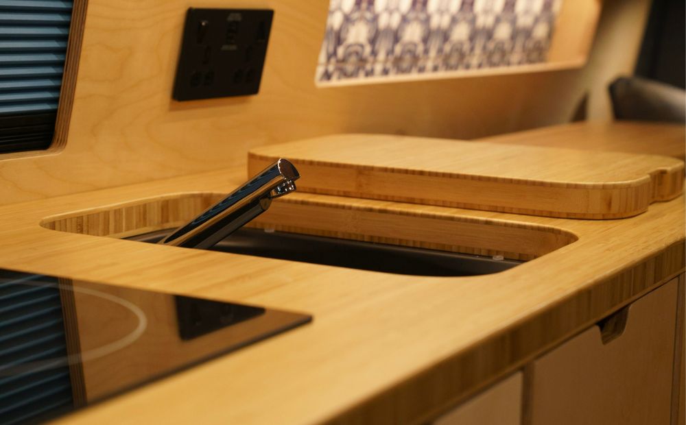 Sink and tap in wooden campervan kitchen 