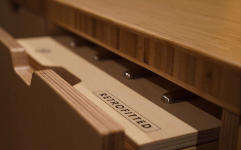 Open wooden drawer showing Retrofitted logo