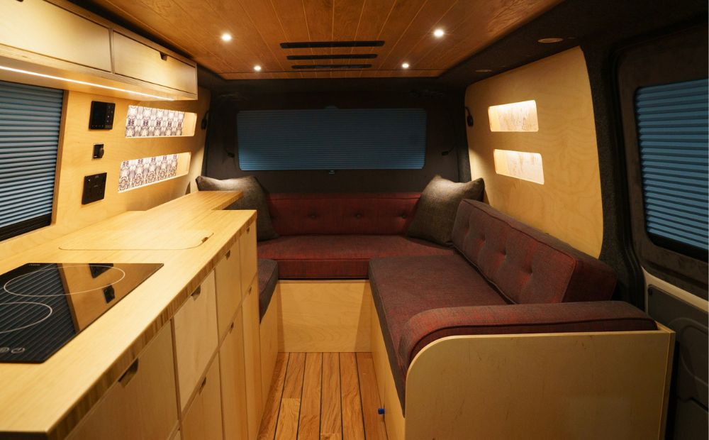 Burgundy sofa bed in U shape campervan conversion 