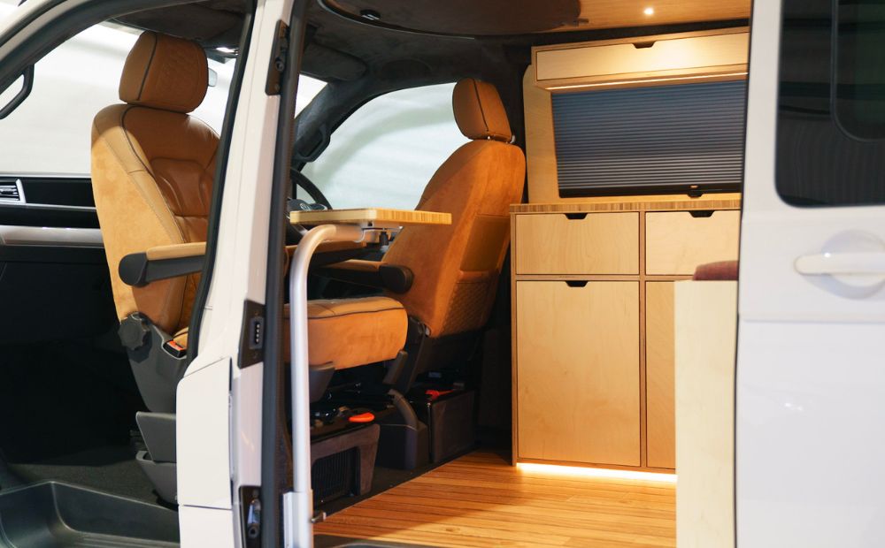 Sliding door open showing wooden kitchen inside campervan