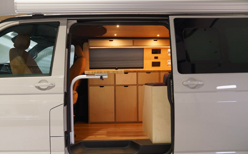 Open sliding door showing campervan kitchen 