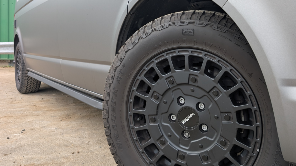 black alloy wheel on grey van