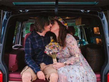 Two people kissing in the back of a campervan