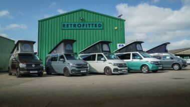 Converted VW campervans with pop tops open