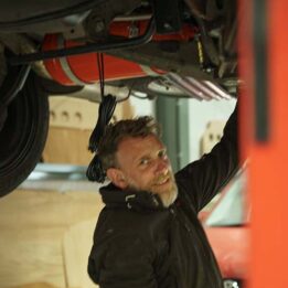 Man working underneath a campervan